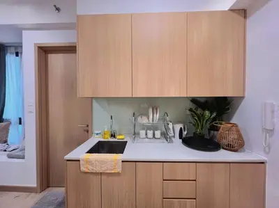 a kitchen with a sink and wooden cabinets at 3PX Suite @Colony Near Quill City Mall&Monorail in Kuala Lumpur