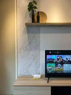 a television sitting on top of a wooden table at Idyllic Cottage 3BR Desa Park City Mont Kiara in Kuala Lumpur