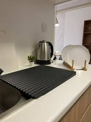 a kitchen counter with a black cutting board on it at Idyllic Cottage 3BR Desa Park City Mont Kiara in Kuala Lumpur