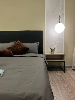 a bedroom with a large bed and a lamp at Idyllic Cottage 3BR Desa Park City Mont Kiara in Kuala Lumpur