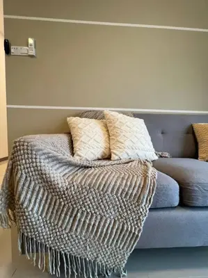 a couch with pillows on it in a living room at Idyllic Cottage 3BR Desa Park City Mont Kiara in Kuala Lumpur