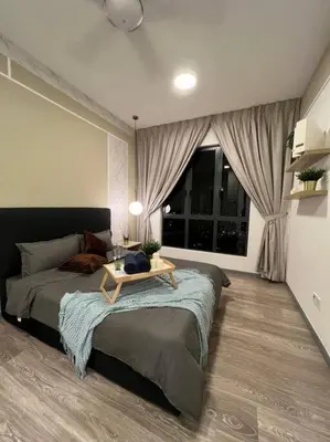 a bedroom with a bed with a table on it at Idyllic Cottage 3BR Desa Park City Mont Kiara in Kuala Lumpur