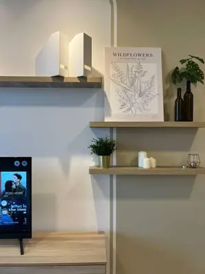 a room with shelves and a tv on a wall at Idyllic Cottage 3BR Desa Park City Mont Kiara in Kuala Lumpur