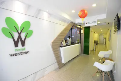 a lobby of a hotel with a sign on the wall at Hotel Westree KL Sentral in Kuala Lumpur