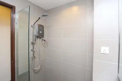 a shower with a shower head in a bathroom at Hotel Westree KL Sentral in Kuala Lumpur