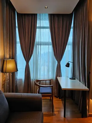a living room with a couch and a table and a window at Premier 2BR Suites, Dua Sentral in Kuala Lumpur