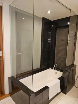 a bathroom with a tub with a glass shower at Premier 2BR Suites, Dua Sentral in Kuala Lumpur