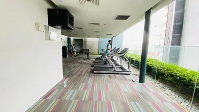 an empty room with chairs and people in a building at Summer suites KLCC by cozy stay in Kuala Lumpur
