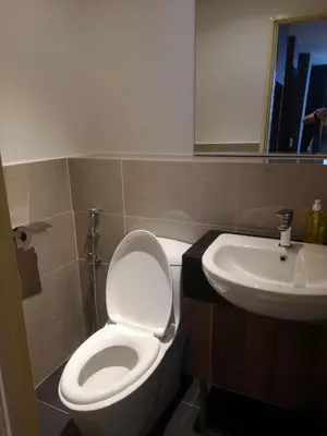 a bathroom with a white toilet and a sink at Imperial Suites @Bangsar by Plush in Kuala Lumpur