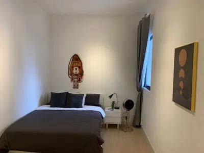 a small bedroom with a bed and a night stand at Continew by Plush Services in Kuala Lumpur
