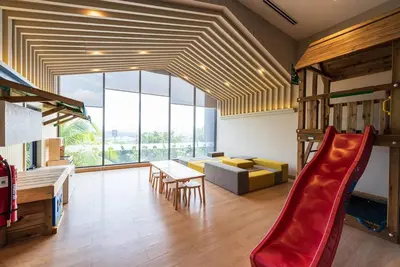 a living room with a slide and a couch at Continew by Plush Services in Kuala Lumpur