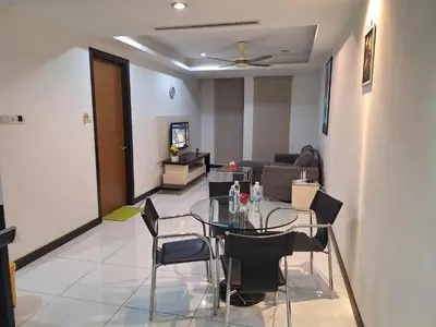 a dining room with a glass table and chairs at 09-7 Sweet Home-Casa Residency in Kuala Lumpur