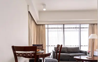 a living room with a couch and a table at Suites at TimesSquare by Plush in Kuala Lumpur