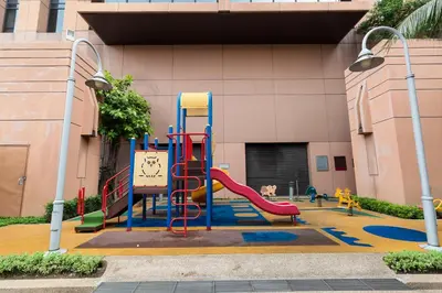 a playground with a slide in front of a building at Suites at TimesSquare by Plush in Kuala Lumpur