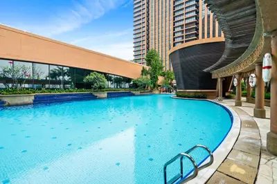 a large swimming pool in front of a building at Suites at TimesSquare by Plush in Kuala Lumpur
