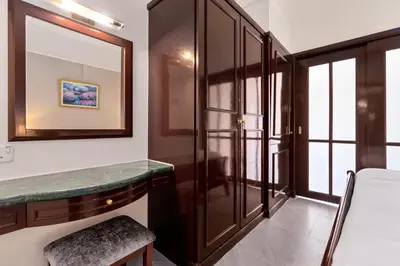 a dressing room with a mirror and a dressing table at Suites at TimesSquare by Plush in Kuala Lumpur