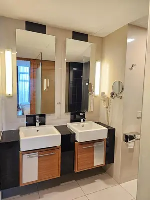 a bathroom with two sinks and a large mirror at Deluxe Family, Dua Sentral in Kuala Lumpur