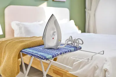 a iron is sitting on a hospital bed at Trion Kuala Lumpur by Cobnb in Kuala Lumpur