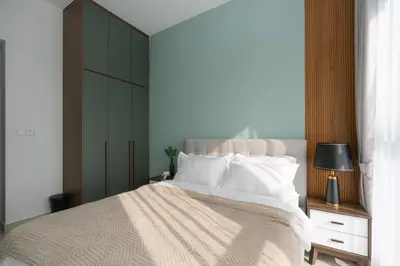 a bedroom with a large bed with white pillows at Trion Kuala Lumpur by Cobnb in Kuala Lumpur
