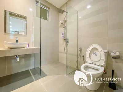 a bathroom with a toilet and a sink and a shower at Binjai 8 by Plush in Kuala Lumpur
