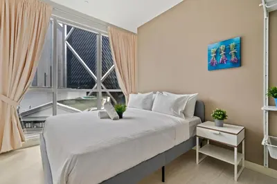 a bedroom with a large bed and a large window at Binjai 8 by Plush in Kuala Lumpur