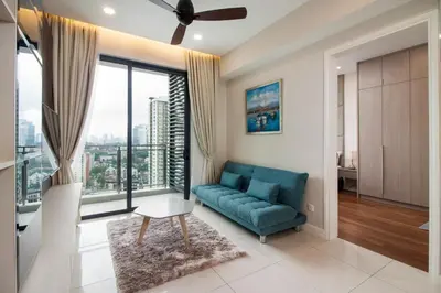 a living room with a couch and a large window at Nadi Bangsar by Plush in Kuala Lumpur