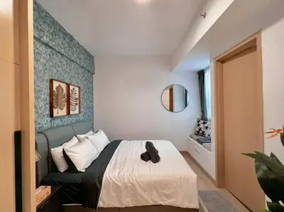 a bedroom with a bed with a blue accent wall at 7PX 2BR Family Gathering Loft @ Colony, Near Quill City Mall & Monorail in Kuala Lumpur
