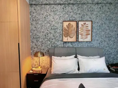 a bedroom with a bed with three pictures on the wall at 7PX 2BR Family Gathering Loft @ Colony, Near Quill City Mall & Monorail in Kuala Lumpur