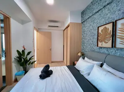 a teddy bear sitting on a bed in a bedroom at 4PX Loft @ Colony, Near Quill City Mall & Monorail in Kuala Lumpur