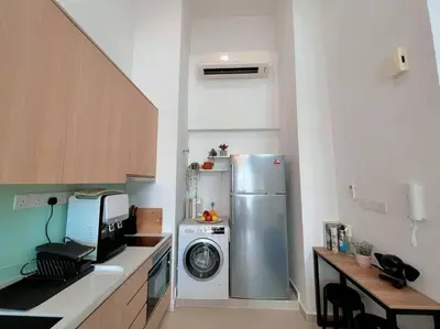 a kitchen with a refrigerator and a washing machine at 4PX Loft @ Colony, Near Quill City Mall & Monorail in Kuala Lumpur
