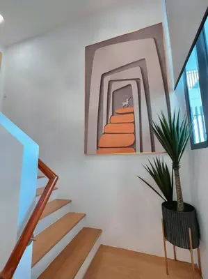 a stairway with a painting and a plant in a room at 4PX Loft @ Colony, Near Quill City Mall & Monorail in Kuala Lumpur