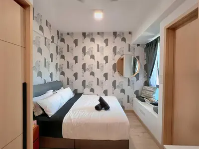a bedroom with a bed and a mirror on a wall at Comfy & Cozy Suites 3PX @ Colony, Near Monorail & Quill City Mall in Kuala Lumpur