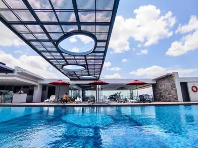 a swimming pool with a view of a building at Cozy Suites @ D’majestic Place, KL City Centre in Kuala Lumpur