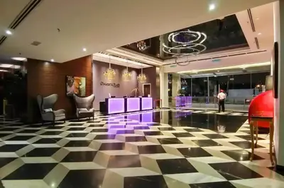 a lobby with a black and white checkered floor at Cozy Suites @ D’majestic Place, KL City Centre in Kuala Lumpur
