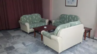 two chairs and a table in a room at Golden City Apartment - Leisure Holiday Resorts in Kuala Lumpur