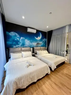 two beds in a bedroom with a mural of a moon at SOGO PWTC KLCC Monorail link Quill Mall 7Pax in Kuala Lumpur