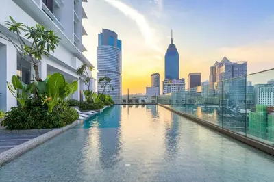 a swimming pool with a city skyline in the background at SOGO PWTC KLCC Monorail link Quill Mall 7Pax in Kuala Lumpur