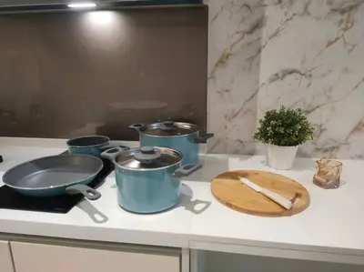 a counter with three pots and pans on a stove at SOGO PWTC KLCC Monorail link Quill Mall 7Pax in Kuala Lumpur