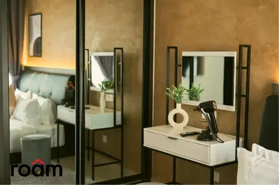 a room with a bedroom with a bed and mirrors at Trion Kuala Lumpur by Roam in Kuala Lumpur