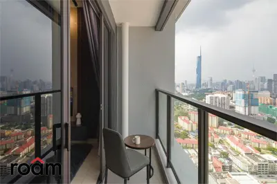 a room with a table and a view of a city at Trion Kuala Lumpur by Roam in Kuala Lumpur