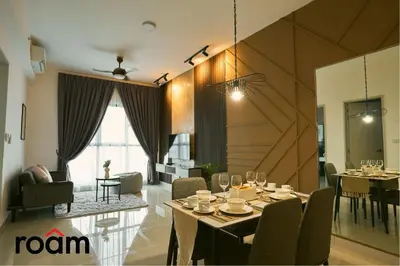 a dining room and living room with a table and chairs at Trion Kuala Lumpur by Roam in Kuala Lumpur