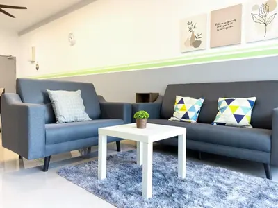 a living room with a couch and a table at Cozy 2-bed retreat - F&B Mart - Chan Sow Lin in Kuala Lumpur