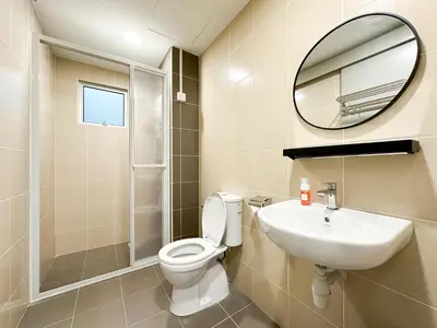 a bathroom with a toilet and a sink and a mirror at Cozy 2-bed retreat - F&B Mart - Chan Sow Lin in Kuala Lumpur