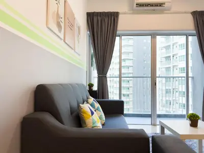 a living room with a couch and a large window at Cozy 2-bed retreat - F&B Mart - Chan Sow Lin in Kuala Lumpur