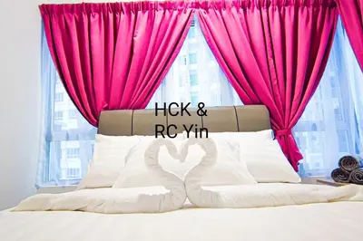 a pink bedroom with a bed with a pink curtain at Lovely Family Suites at Razak City by HCK in Kuala Lumpur