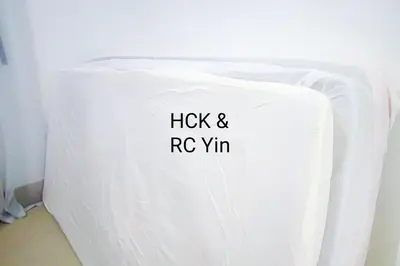 a white chair with the words hick and rv vim on it at Lovely Family Suites at Razak City by HCK in Kuala Lumpur
