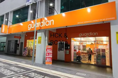 a store with an orange sign on the side of a building at Lovely Family Suites at Razak City by HCK in Kuala Lumpur