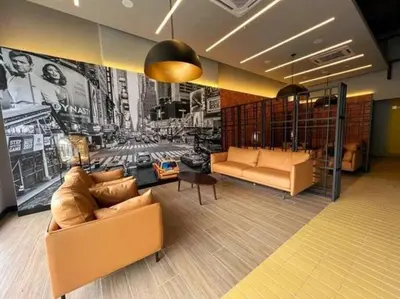 a living room with couches and a mural of a city at Studio Room near Gleneagles @ Embassy Row KLCC in Kuala Lumpur