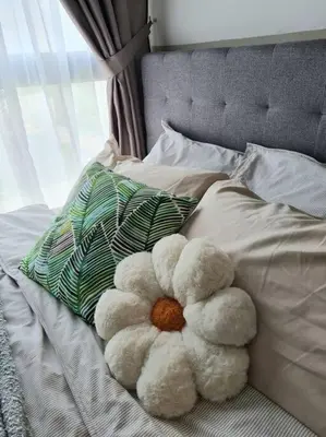 a teddy bear sitting on top of a bed at Studio Room near Gleneagles @ Embassy Row KLCC in Kuala Lumpur