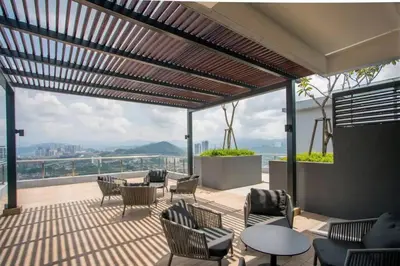 a patio with chairs and tables and a view at Studio Room near Gleneagles @ Embassy Row KLCC in Kuala Lumpur